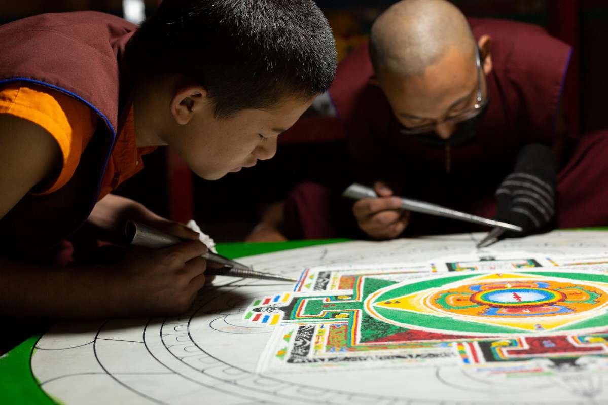 A young monk learns the finer techniques of making a sand mandala. Dorje Drak Monastery, 2019. Photo by Jonathan Greet.